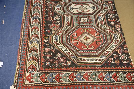 An antique Caucasian polychrome ground rug, 7ft 5in by 4ft 4in.